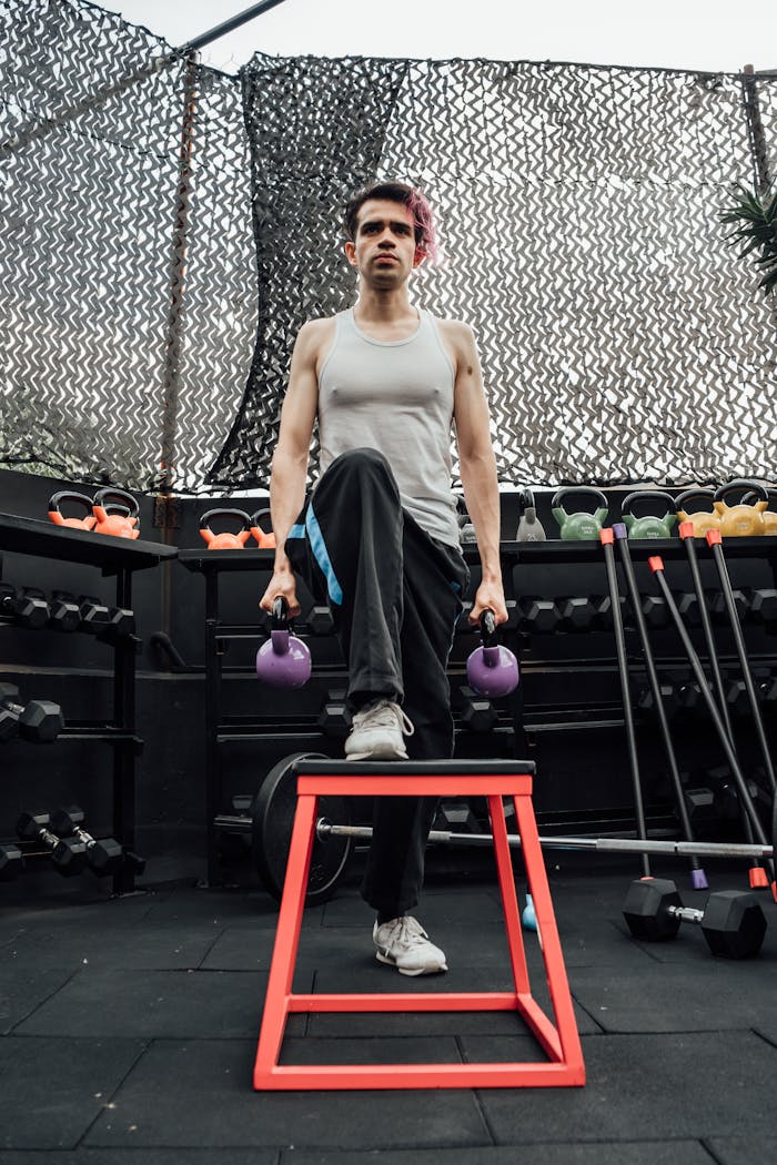 A man works out in a Mexico City gym, lifting kettlebells for strength training.